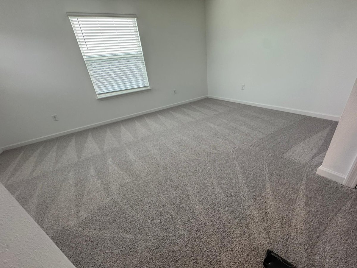 Freshly cleaned empty room with carpet vacuum lines